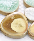 Close-up of Pebble Porcelain Mosaic Tile Set Dope Glossy Aqua Cream Coffee Mix for Bathroom Walls Shower Floors Spa Decor