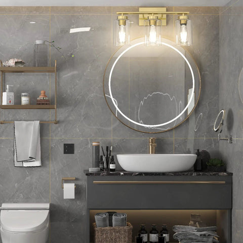 Brushed Brass Modern Bathroom Light Fixtures With Clear Glass Shade Three Light Vanity Wall Sconce illuminating a stylish bathroom