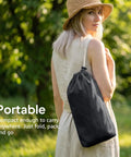Woman carrying Cotton Portable Camping Hammock With Tree Straps Up To 660 Lbs Travel Bag in park setting