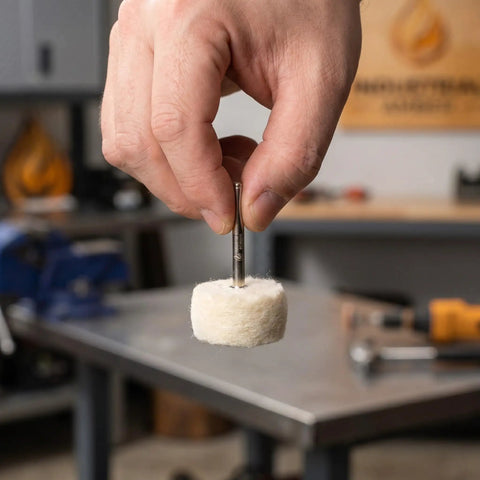 Hand holding a 50 Piece Wool Polishing Buffing Wheel For Drill Attachments with White Cashmere Felt in workshop