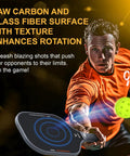 Action shot with Set Of 2 Pickleball Paddles With Raw Carbon And Glass Fiber Surface, player in orange shirt hitting a ball.