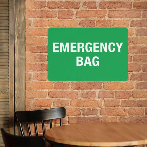 Emergency First Aid Sign For Outdoor Use 8 By 12 Inch Wall Decor on brick wall above wooden chair and table