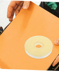 Heavy Duty Strapping Tie Roll For Easy Bundling And Shipping on an orange surface near hands