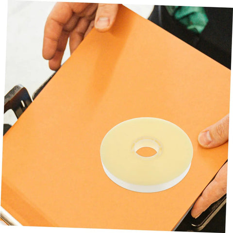 Heavy Duty Strapping Tie Roll For Easy Bundling And Shipping on an orange surface near hands