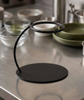 Heavy Duty Coffee Filter Holder Funnel Stand With Slick Black Iron Base For Hands Free Drip Pour Over Brewing on kitchen counter.