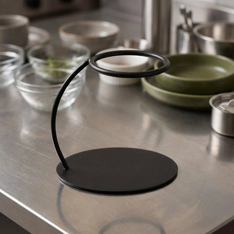 Heavy Duty Coffee Filter Holder Funnel Stand With Slick Black Iron Base For Hands Free Drip Pour Over Brewing on kitchen counter.
