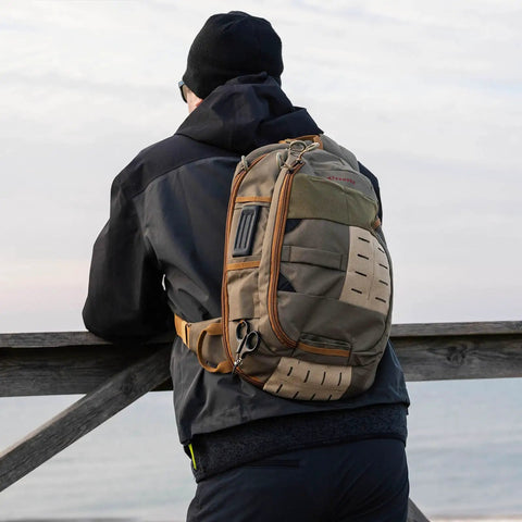 Fly Fishing Sling Pack With Quick Access Chest Design For River Runs visible on a person outdoors.
