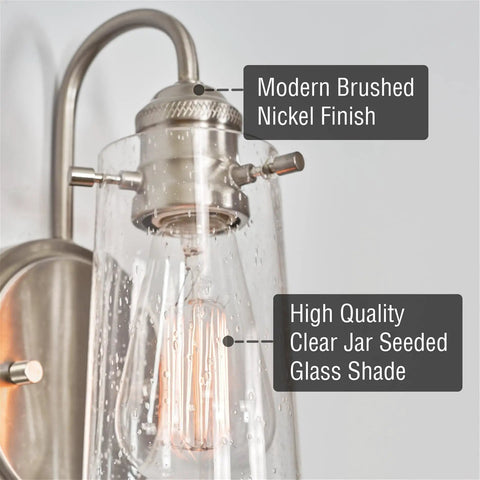 Close-up view of Kira Home Rayne 10" Modern Farmhouse Wall Sconce for Bathroom Vanity showcasing brushed nickel finish and glass shade.