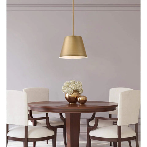 Dining area with Derose Transitional One Light Indoor Pendant Light in brushed brass finish hanging over wooden table with flowers