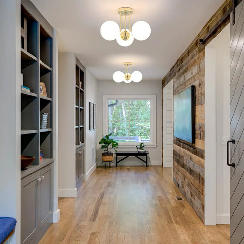 Gold 3 Light Semi Flush Mount Ceiling Light Fixture With Off White Hand Blown Glass Shade illuminates a modern hallway.