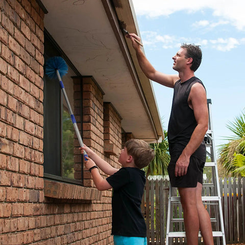 Father and child using a Stainless Steel Pole Cobweb Duster With 4Ft Extendable Reach And Medium Stiff Bristles for cleaning.
