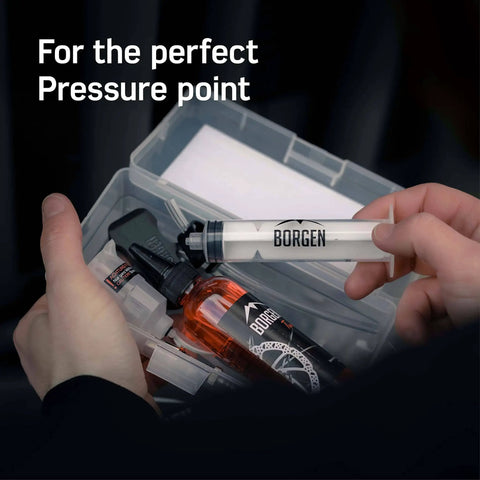 Hands holding syringe from All In One Shimano Hydraulic Brake Bleed Kit For Disc Brakes With 100 Ml Mineral Oil, Gloves And Bleed Block.