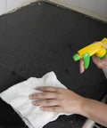 Person cleaning counter with white linen terry bar mop towel 14x17 from value pack of 60, using spray bottle