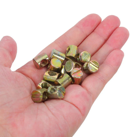 Super Cool 100 Pack M6 Threaded Inserts For Furniture Nuts Screws And Bed Connectors shown in hand, metallic light brown, used for furniture repair.