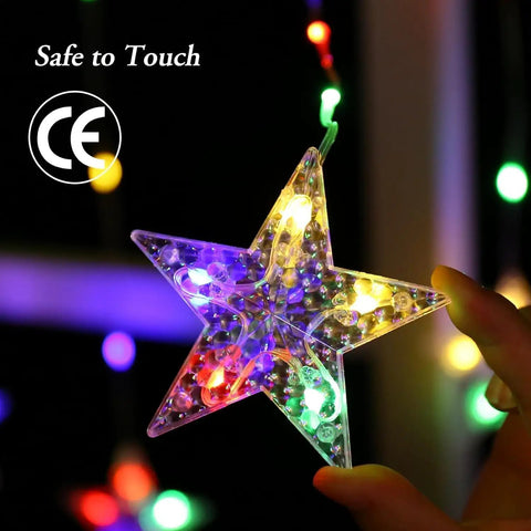 Color Changing Star Window Christmas Lights With 9 Star Curtain Ornaments Multicolor And Warm White Battery Operated With Timer 8 Modes IP65 Waterproof Xmas Window Decor For Indoor And Outdoor Use close-up on illuminated star ornament revealing colorful LED lights in dark background.