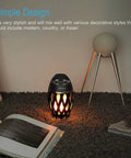 LED Flame Outdoor Table Lamp With Bluetooth Speaker Rechargeable Ambience Lantern on carpet with books and decor
