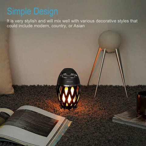 LED Flame Outdoor Table Lamp With Bluetooth Speaker Rechargeable Ambience Lantern on carpet with books and decor