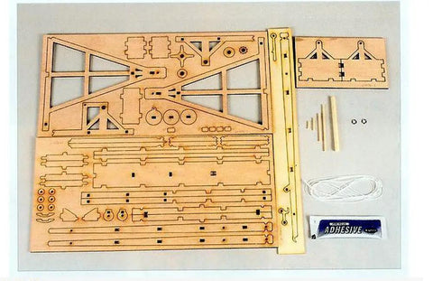 Wooden Trebuchet Desktop Model Kit For Adults A Hardcore Hobby Project pieces and adhesive displayed on a tabletop.