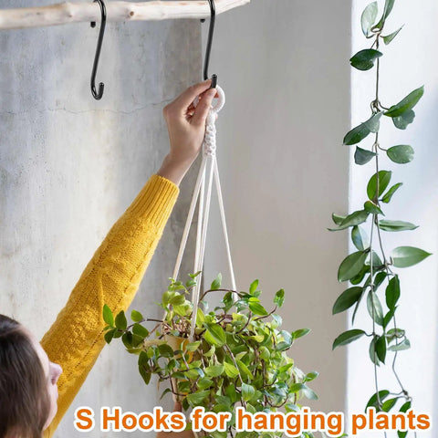 Person using 10 Pack 6 Inch Heavy Duty Vinyl Coated S Hooks Non Slip Black For Hanging Plants on wall-mounted rack.