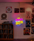Colorful 'Back to the 80s' neon sign on dark wall near vinyl records and retro posters in music-themed room