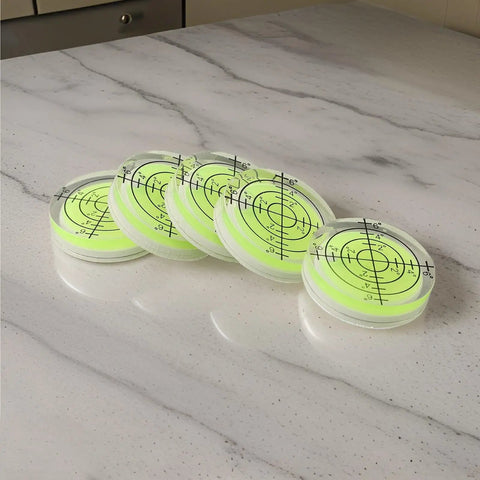 for spirit Bubble Level for Precision Measuring and Layout Tasks, set of translucent levels with markings on a marble surface.
