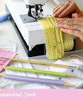 FQTANJU quick-turn fabric tube turner set, 3-piece with colored sleeves and wooden ends beside a sewing machine.