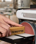 Hand using Abrasive Cleaning Stick For Sanding Belts And Discs Eight And A Half Inches Natural Rubber Eraser on sanding machine
