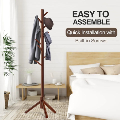 Freestanding Coat Rack With 8 Hooks And 3 Adjustable Tree Sections For Bedroom shown in a bedroom setting with clothes hanging.