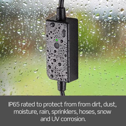 Heavy Duty Smart WiFi Outdoor Plug With Hella Weather Resistant Shell For Holiday Lights Yard Decor And Garden Pumps Matter Enabled Voice Control Switch In Matte Black showing IP65 protection from moisture and weather.