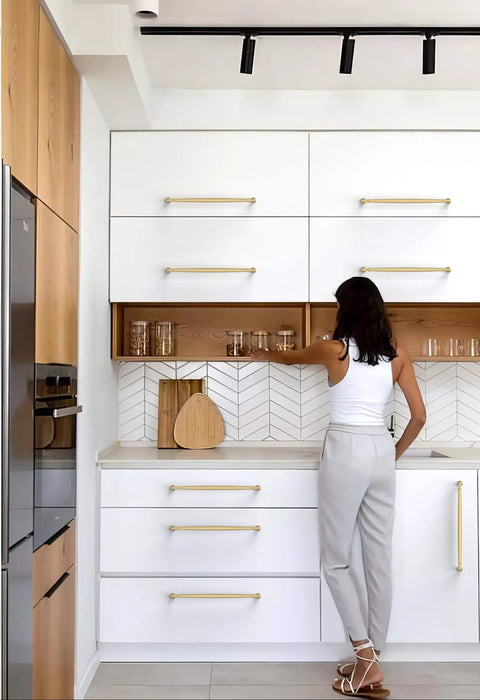 Talentedeco 10 Pack Brushed Gold Kitchen Cabinet Pulls in modern kitchen with white cabinets and wood elements.