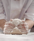 Baker kneading dough using One Gallon Baking Soda For Cooking And Baking Cleaning And More Pure Sodium Bicarbonate With Nothing Added.