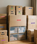 Stacked boxes labeled with Rainbow Masking Tape Set With Twelve Rolls Of Colorful Painter Tape One Inch By Seven Hundred Twenty Feet Each