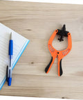 Phone Screen Repair Kit With Suction Cup Pliers For Quick Screen Opening on a wooden table next to a pen and notebook