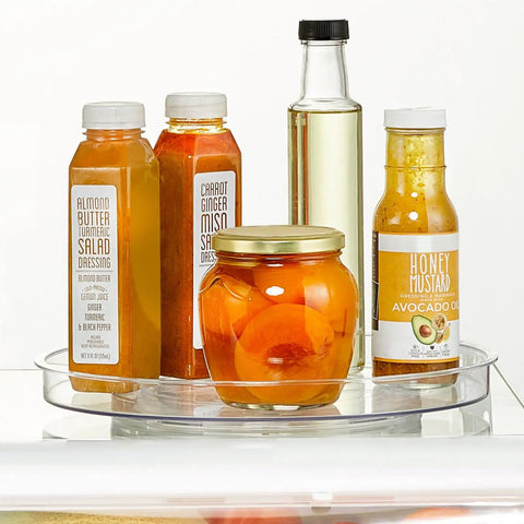 Slick Rotating Lazy Susan Turntable Spinner Fully Swiveling 11.5 Inch Clear Plastic Round Organizer with sauces in fridge.