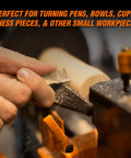 WEN mini benchtop wood lathe turning wooden piece with orange clamps visible
