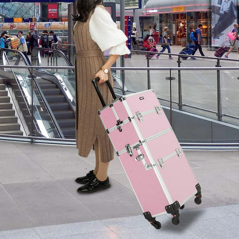 Woman at airport with 2 In 1 Rolling Makeup Case For Travel And Studio, Aluminum Frame Cosmetic Train Case, pink color, on wheels