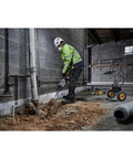 Pro 60V Brushless Breaker Hammer Kit Built As A Straight Shooter Heavy Hitter breaking up concrete in a construction site.
