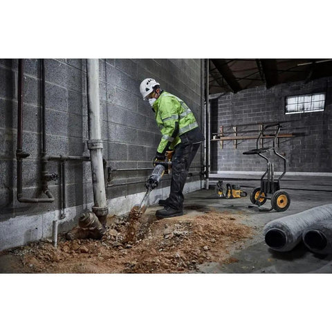 Pro 60V Brushless Breaker Hammer Kit Built As A Straight Shooter Heavy Hitter breaking up concrete in a construction site.