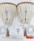 Bohemian Wood Beaded Wall Sconces Two Pack White Finish setup with parts and instructions on display