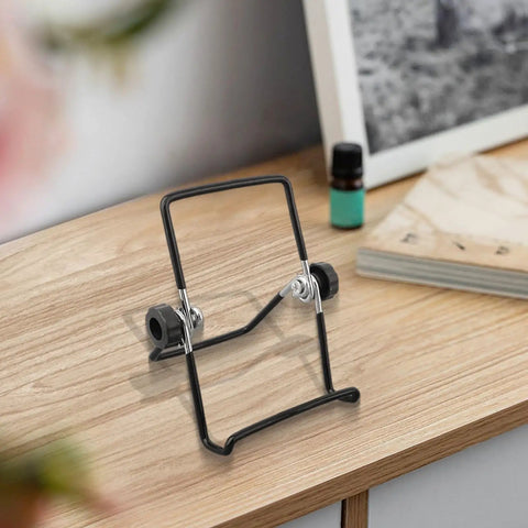 2 Pack Foldable Solar Panel Mounting Brackets showing adjustable metal stand on wooden table in black finish.