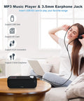 Bluetooth Speaker With FM Radio And 5 In 1 Music Player Bluetooth Streaming USB SD Card MP3 AUX on table with woman enjoying music