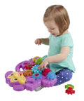 Child playing with Totally Awesome Dope Monkey Gears Stacking And Spinning Toy With Nine Interchangeable Plastic Cogs.