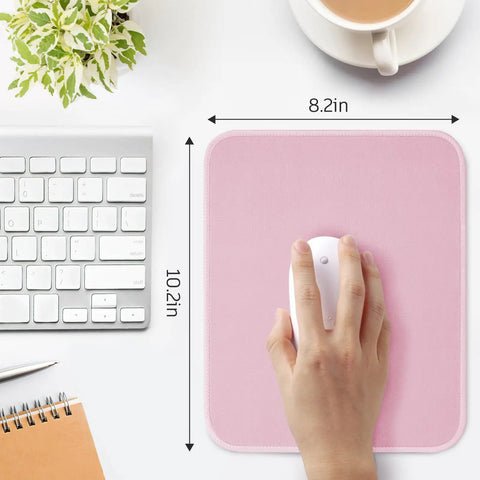 Pink Mouse Pad With Splash Proof Textured Surface And Stitched Edge For Desk, Non Slip Waterproof Rubber Base, 10.2 X 8.2 Inches shown with hand using a mouse.