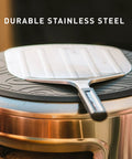 Stainless Pizza Peel With Built In Ridges Serving Board And Pizza Paddle For Ovens 304 Stainless Steel shown on a pot