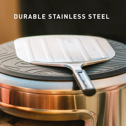 Stainless Pizza Peel With Built In Ridges Serving Board And Pizza Paddle For Ovens 304 Stainless Steel shown on a pot