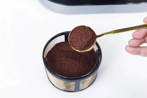 Spoon scooping coffee grounds into Reusable Mesh Coffee Filter For K Duo Hot And Iced Gen 2 And Essentials And Brewers Not Compatible