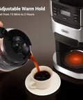 Close-up of 10 Cup Drip Coffee Maker With Built-In Burr Grinder And Programmable Timer For Fresh Ground Coffee Auto Keep-Warm 1.5L Water Tank Reusable Filter Black with coffee being poured into a cup.