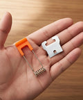 Hand holding Set Of 10 Recessed Lighting Spring Clips For Ceiling Canister Lights And LED Strip Mounting, 55x16mm