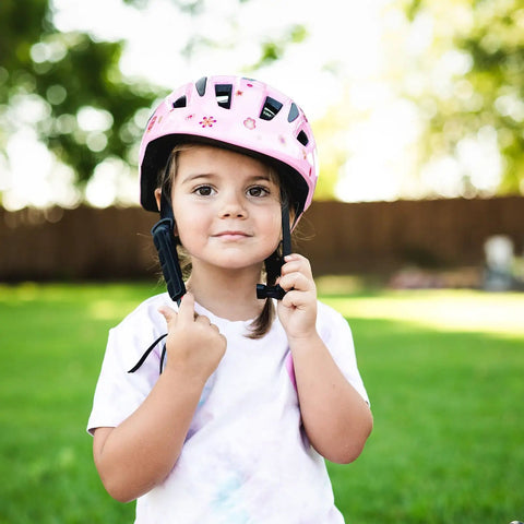 Toddler wearing pink flower pattern Toddler Bike Helmet For 1 Year Old And Up Adjustable Multi Sport Safety Gear outdoors