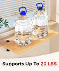 Fold Down Wall Mounted Desk Extender Tray And Side Table That Expands Your Space holding two large water jugs near a window